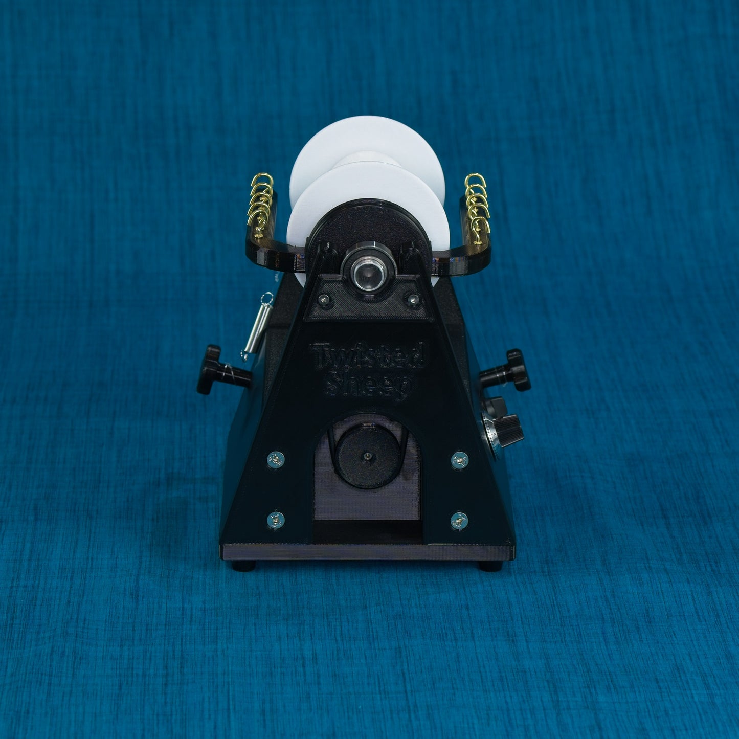 Twisted Sheep portable electric spinning wheel front view showing flyer orifice and drive band