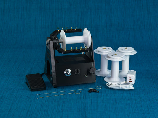 Twisted Sheep portable electric spinning wheel shown with bobbins and accessories